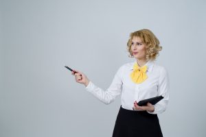 Woman pointing out something with a pen and clipboard